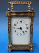 A French carriage clock in ornate gilt c