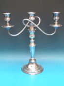 A silver plated three branch candelabra,
