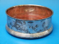 A silver wine coaster with feature hallm