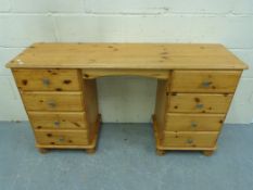 A pine twin pedestal desk (W133 x D38 x