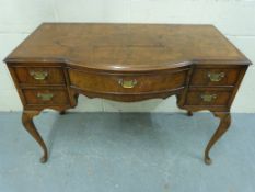A burr walnut dressing table raised on c