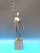 A spelter figure of an athlete holding a