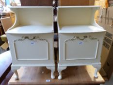 A pair of white painted bedside cabinets