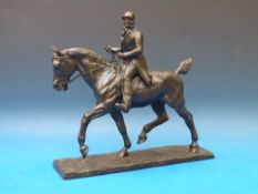 A cast bronze of a horse and rider