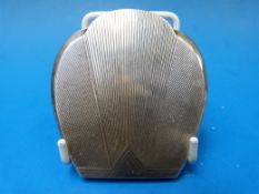 An Art Deco silver compact in the form o