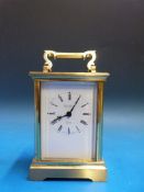 A brass carriage clock retailed by Marti