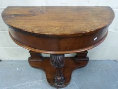 A 19thC mahogany demi-lune carved pier t