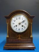 An oak-cased inlaid Edwardian mantel clo