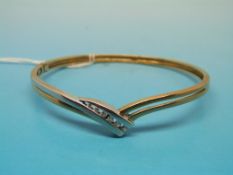 A 9ct gold bangle set with six graduatin