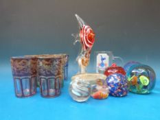 A set of six glass beakers with coloured