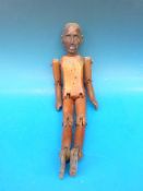 A hand carved articulated wooden artist'