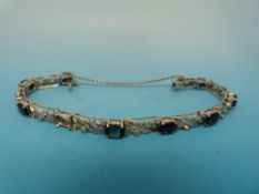 A white metal bracelet marked 750 set wi