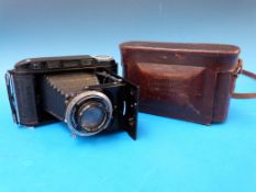A Voigtlander RF folding camera in leath