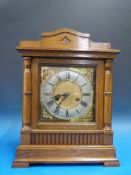 An oak cased bracket mantel clock with t