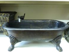 A cast iron trough or jardiniere in the
