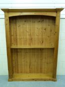A large pine bookcase with facility for