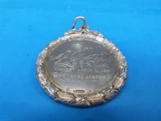A hallmarked silver medal presented to Miss Jane A Burness for Latin at the Montrose Academy by The