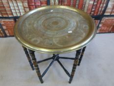 An Eastern brass topped table