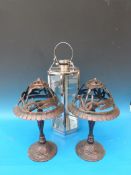 A pair of bronze effect cast candle holders and a contemporary glazed hanging storm lantern