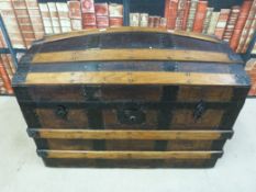 A 19thC metal and ash bound domed trunk with leather carrying handles (68cm long x 45cm wide)