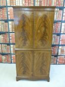 A reproduction flame mahogany drinks cabinet with satin birch interior and glass shelves (126cm