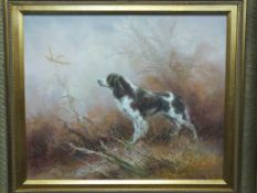 A modern oil painting of a spaniel flushing out a pheasant from undergrowth, in gilt frame
