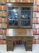 A substantial oak twin pedestal bureau bookcase with three dog tooth adjustable shelves behind a