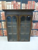 A glazed oak bookcase with adjustable shelves