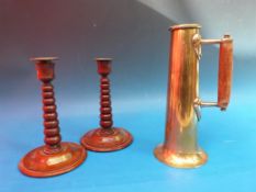A Naval trench art tapering copper jug and a pair of barley twist mahogany candlesticks both HMS