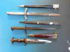Three replica German WW2 style daggers, bayonets etc