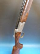 A Browning 525 Prestige 20 bore over and under shotgun with 3/4 1/2 and 1/4 removable chokes, choke