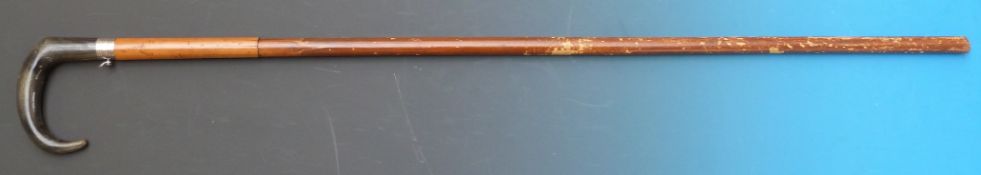 A 7mm centre fire walking stick shotgun with cane covered barrel, buffalo horn handle and button