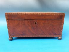A late Georgian mahogany work box with marquetry inlay, flame mahogany top, ball feet and lion mask