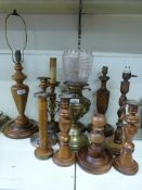 A brass oil lamp and a collection of candlesticks