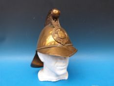 A brass Dublin Fire Brigade helmet with dragons to top