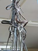 Two snaffle leather bridles both with nosebands together with a leather double bridle