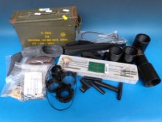 A collection of various gun accessories including cleaning kit, sights, locks, ammunition box etc