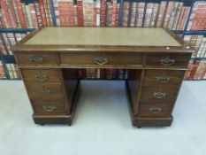A late 19th century/early 20th century leather inset twin pedestal desk