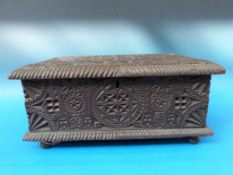 A 19thC continental carved oak box with ploughing scene to inside of lid with additional script