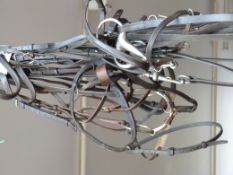 Seven bridles and nose bands, some snaffle