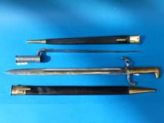 Two replica bayonets in scabbards