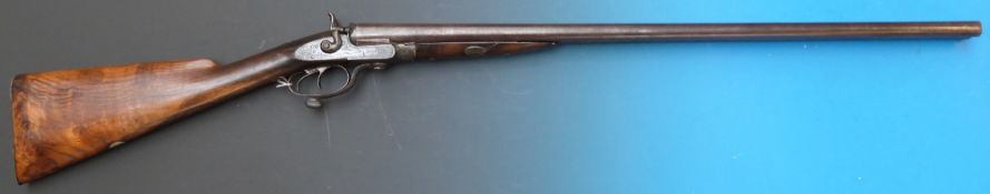 A 12 bore double barrelled side by side hammer action shotgun, all over engraved with scrolling