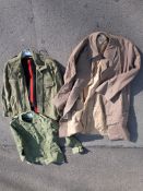 A quantity of military uniform including a raincoat size 8 dated 1963, combat shirt size 3, dress