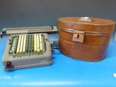 A Swiss Madas mechanical calculator and a vintage metal hat box