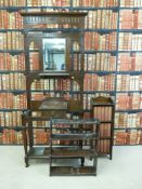 An oak hall stand together with a small set of shelves and a bookcase containing Dickens books