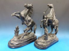 A pair of Marley spelter figures of rearing horses