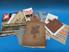 A quantity of German ephemera including WW2 content, passes, newspaper cuttings, Berlin Wall, moon