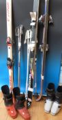 Three sets of skis and poles and two pairs of boots