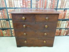 A Victorian stained pine chest of two over three straight graduated drawers with shaped apron (H