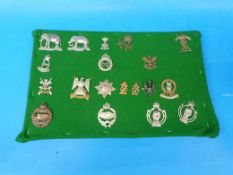 A mixed group of British Army cap badges including Tank Regiment, Royal Armoured Corps, Dragoons,